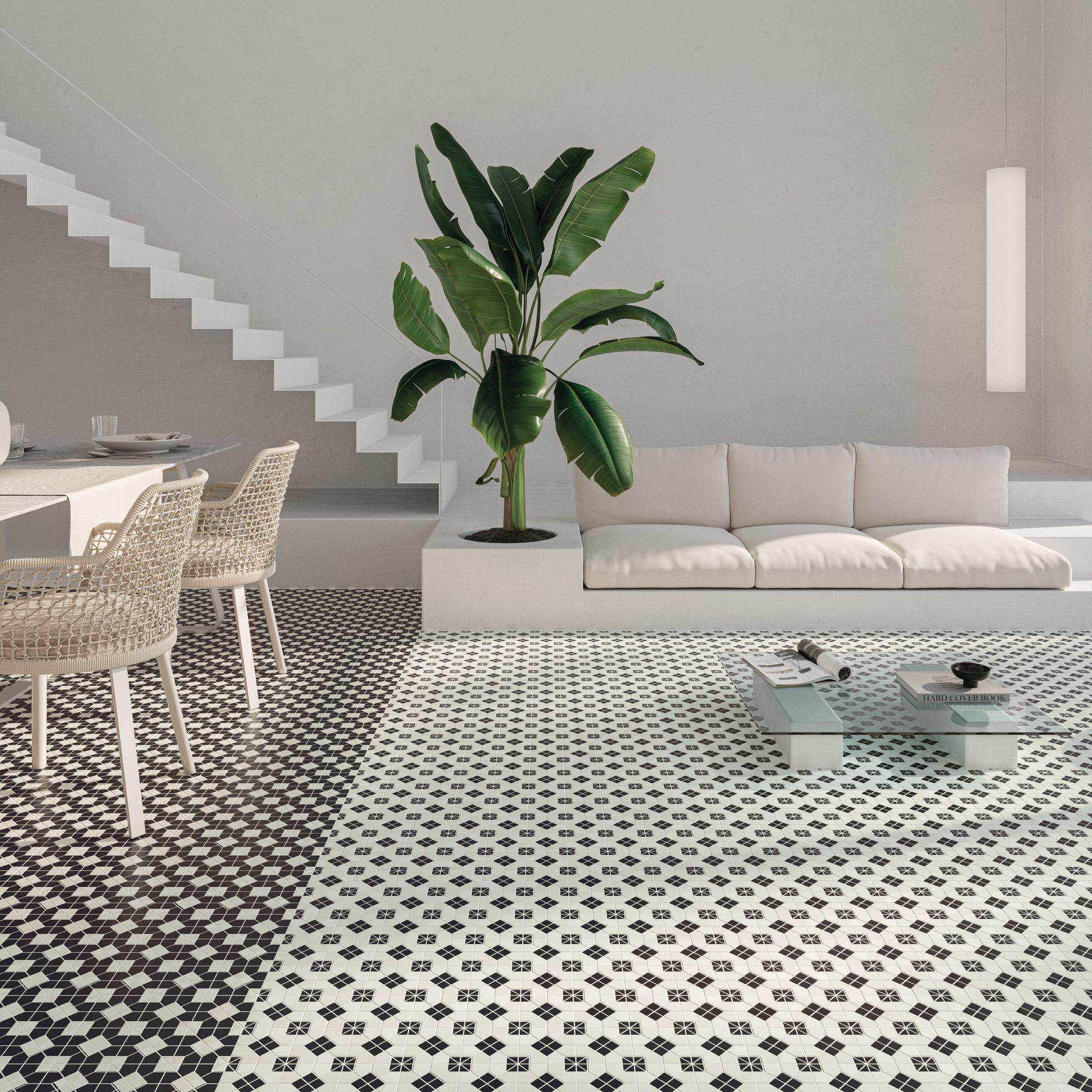 black and white pattern floor tiles used in a living space with a white couch and a glass coffee table and beige dining room chairs