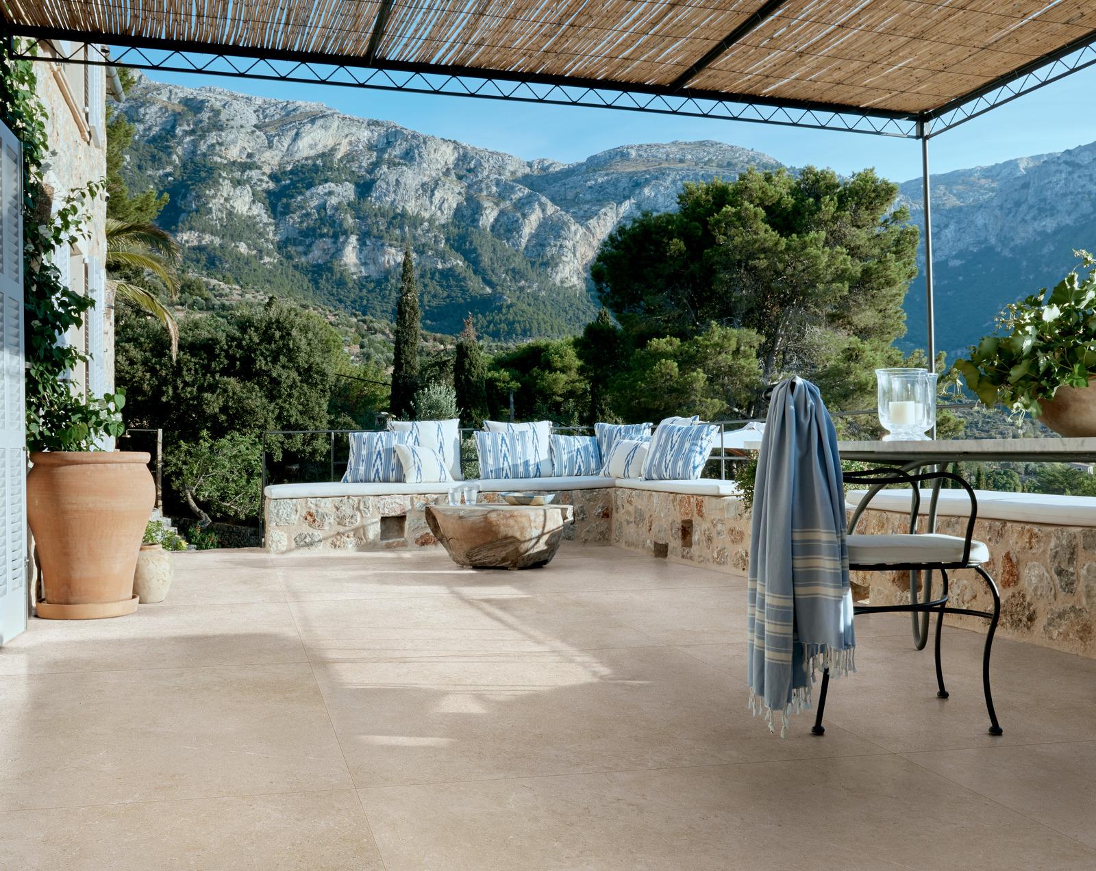 patio tiles, mountain view ,black chair, blue towel,
