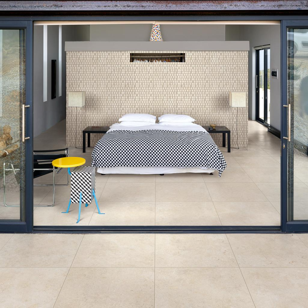 patio tiles, mountain view ,black chair, blue towel,, inside outside tiles