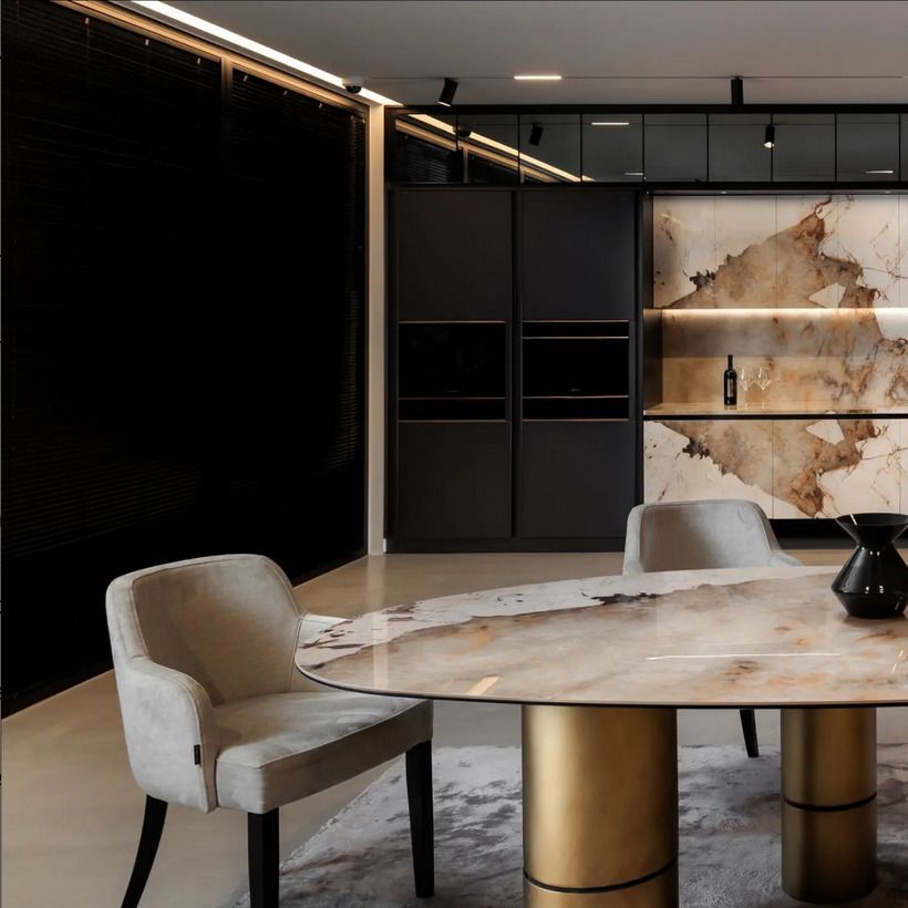 A luxurious bathroom featuring green marble walls and double sinks with matching green marble countertops. Gold faucets add a sophisticated contrast to the rich, green marble.
