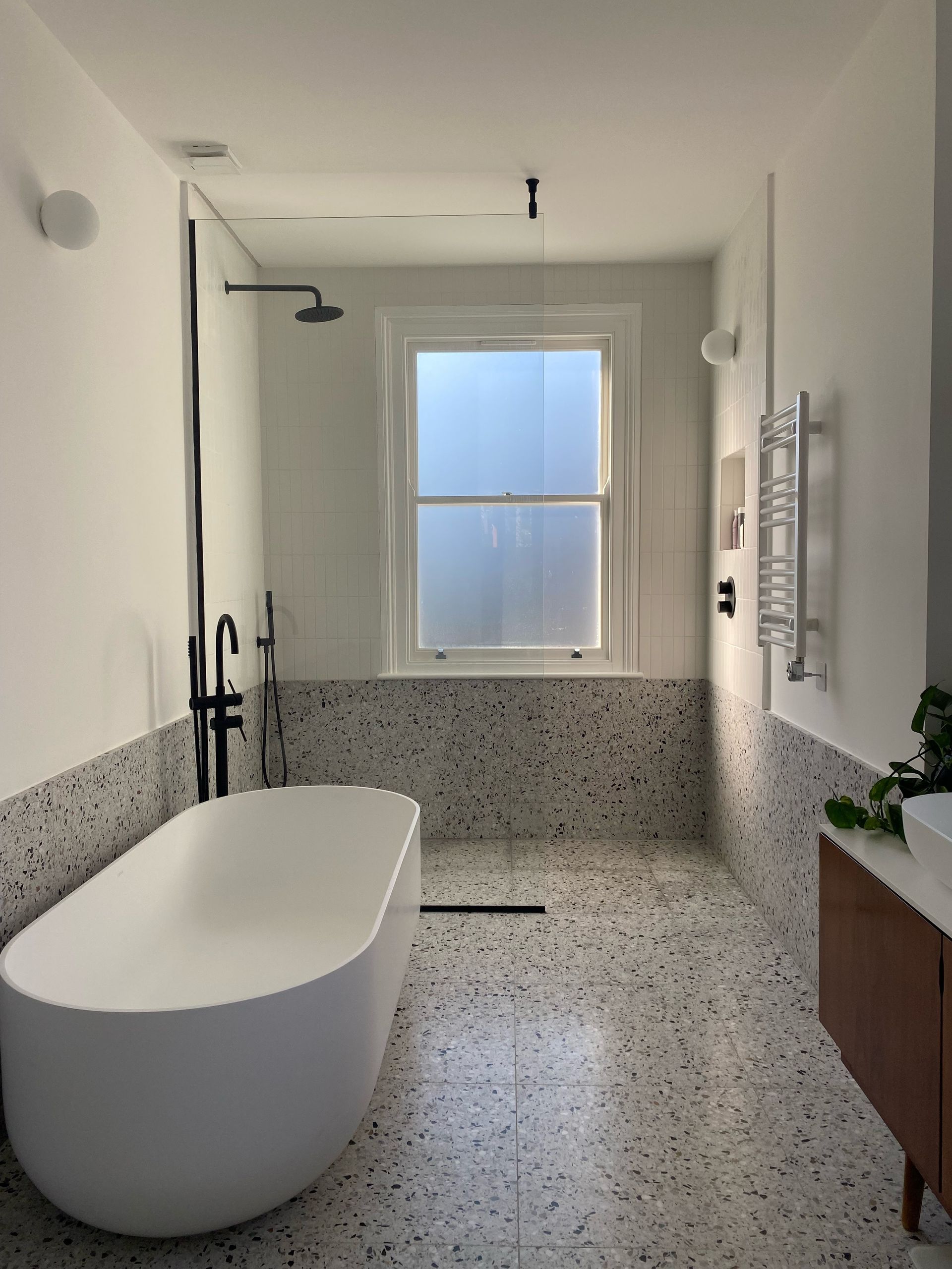 picture of a bathroom with terrazzo tiles and a window