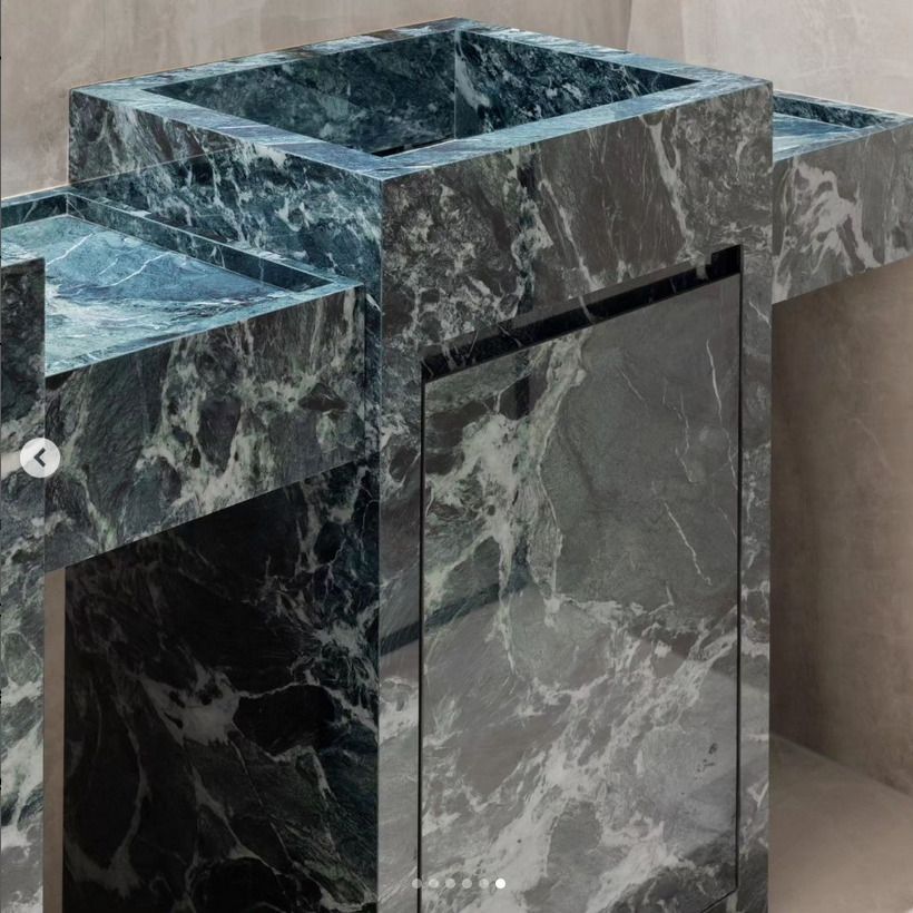 A striking green marble vanity with a geometric design, adding sophistication to any contemporary bathroom space.