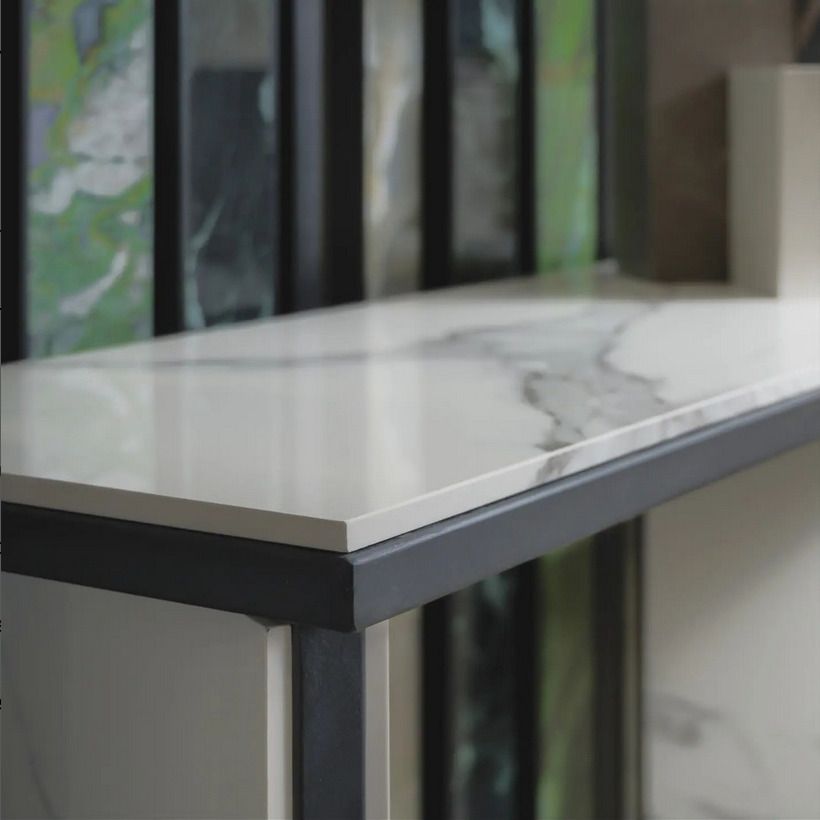 Close-up of a marble-look countertop with sleek, clean lines and a subtle vein pattern, perfect for modern kitchens.