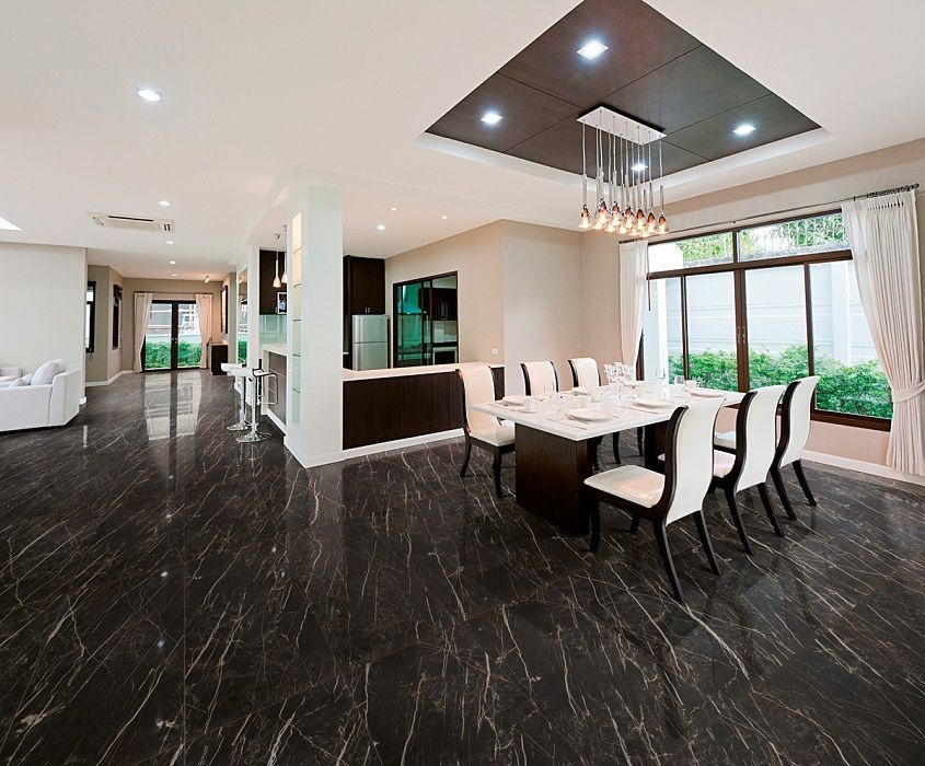 marble floor tiles ,a large open floor kitchen with white chairs and a white table