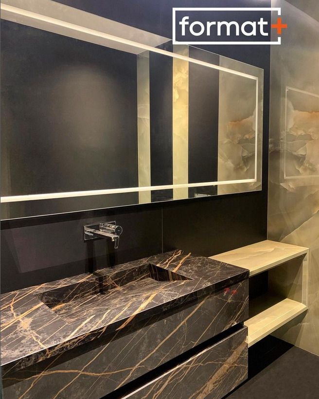 Luxurious bathroom vanity with a black marble top and dark cabinetry, accentuated by a large mirror.