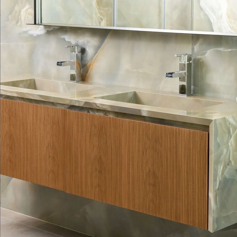 Image of various textured tiles arranged on a shelf with a plant for decoration.