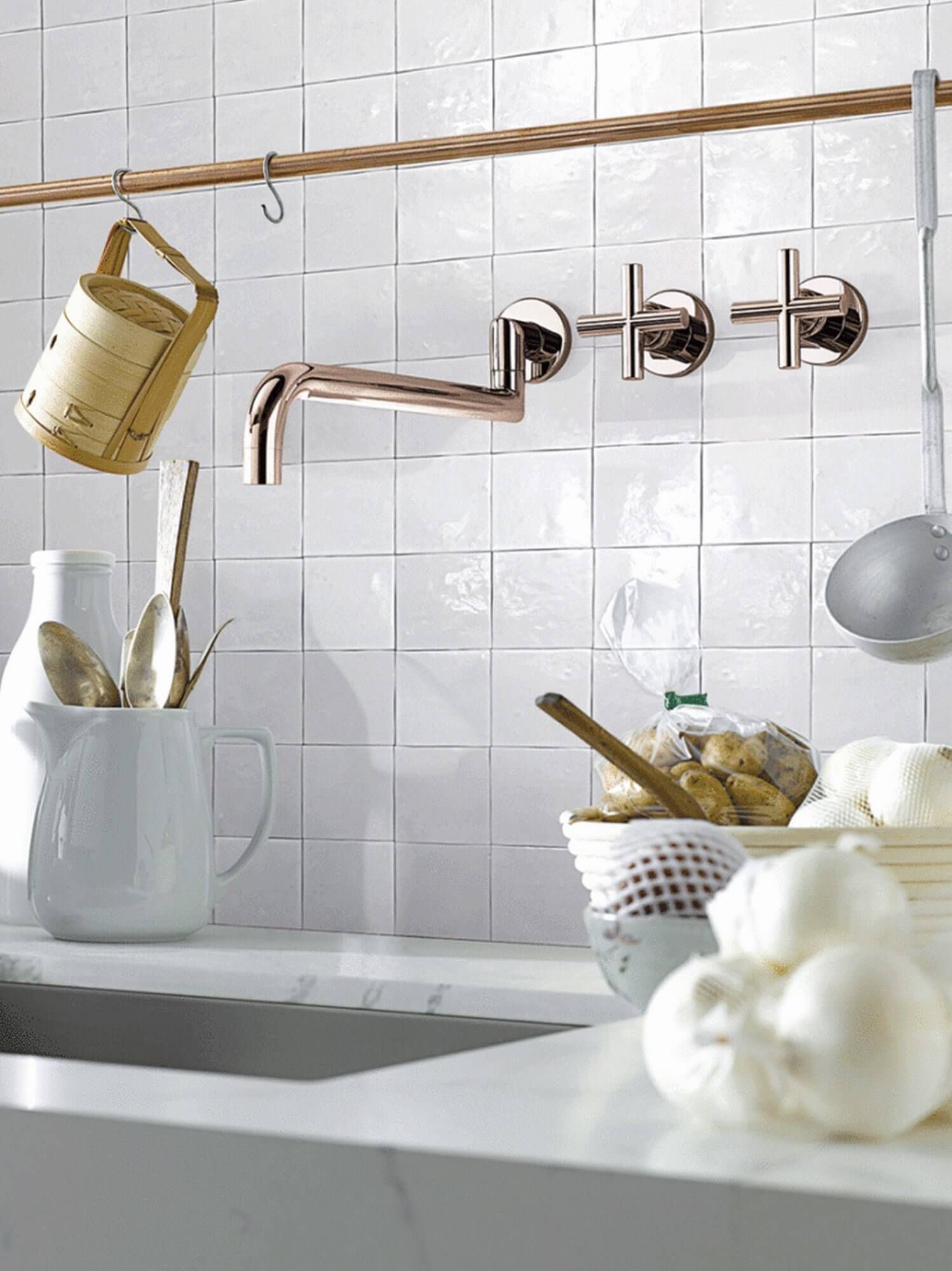 Gloss white square wall tiles used in a bathroom for the bath splashback
