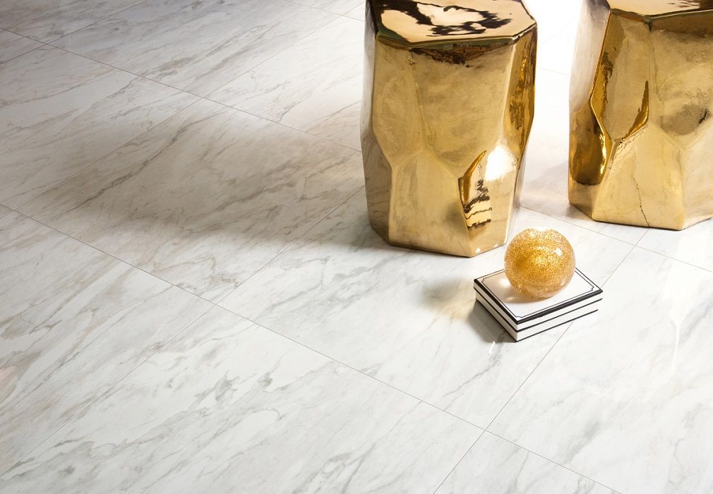marble floor tiles with a golden stand and white books with a black frame