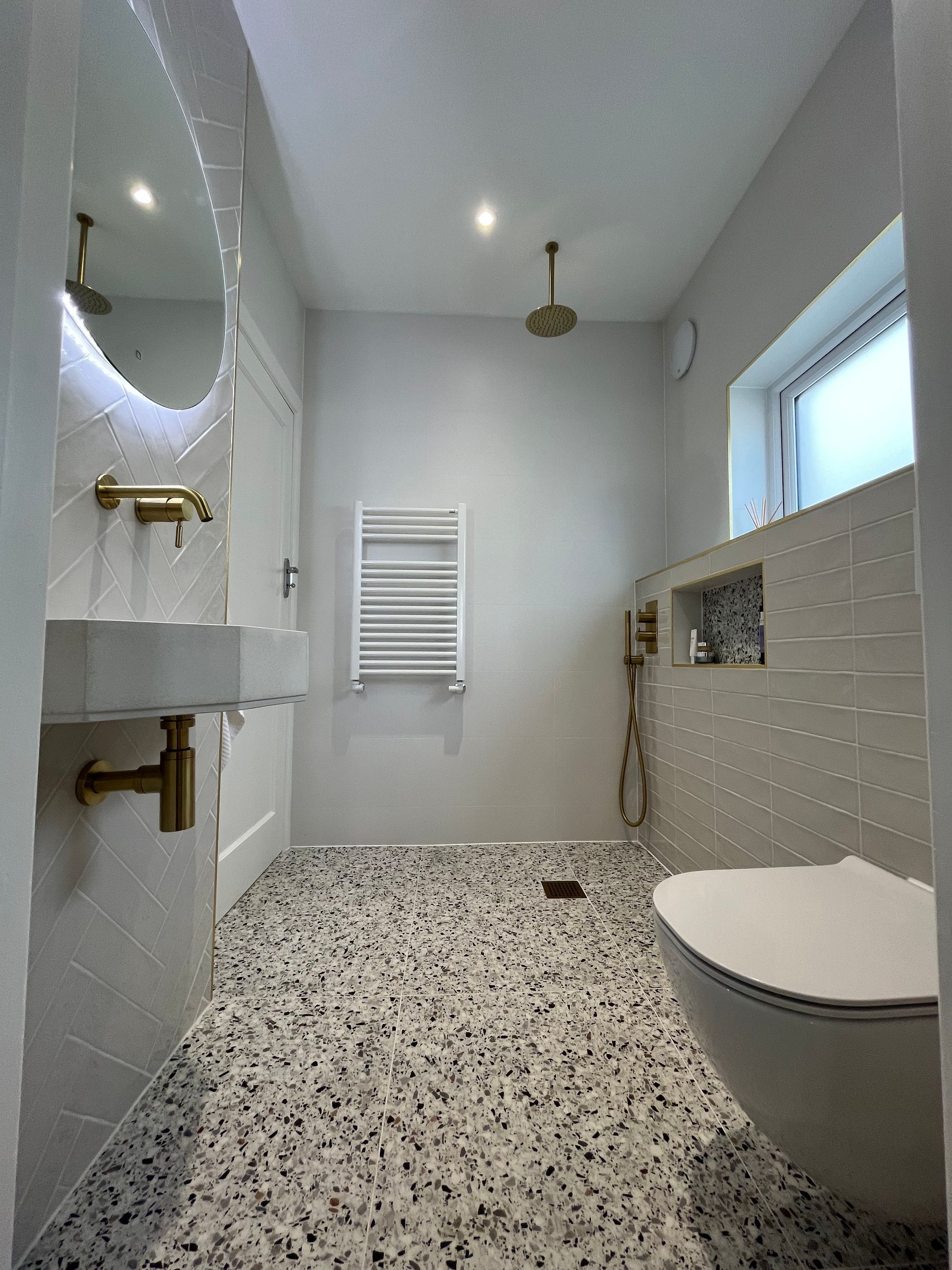 golden taps with ceppo di colour blanco floor tiles with a towel ral