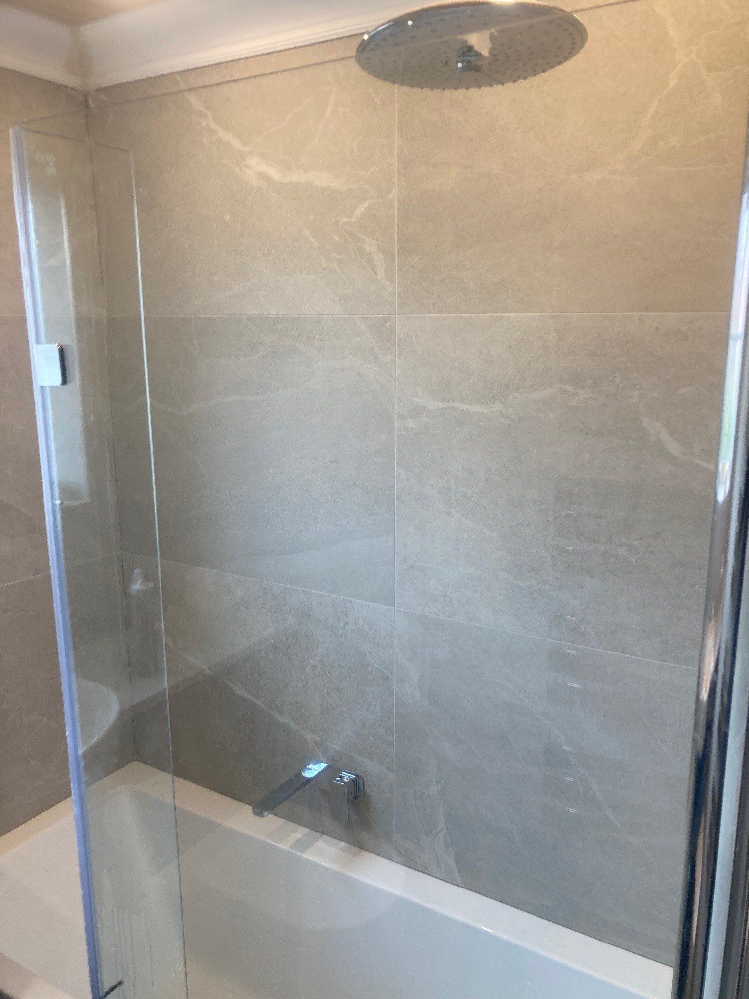 limestone effect tiles , residential bathtub / shower splashback