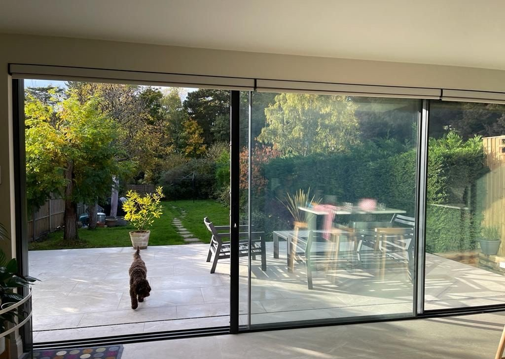 large format floor tile used indoors and outdoors with glass sliding door and outdoor seating