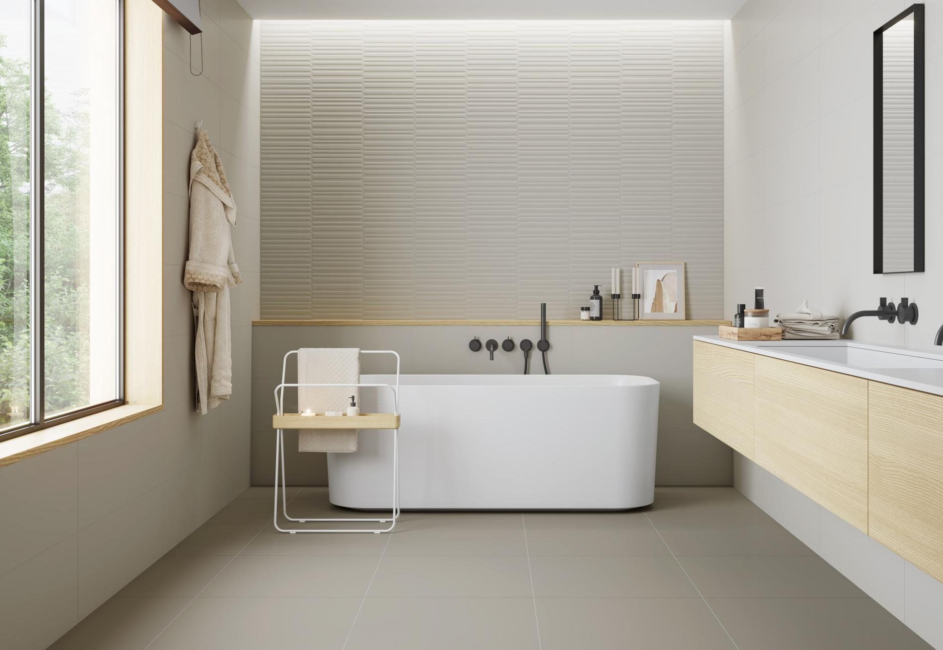Modern bathroom with vertical striped textured wall tiles in beige, a freestanding bathtub, and natural wood vanity for a serene atmosphere.