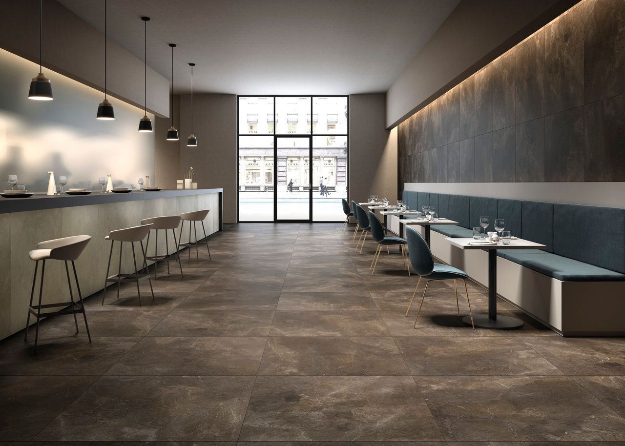 Modern cafe with dark floor tiles and minimalist seating.