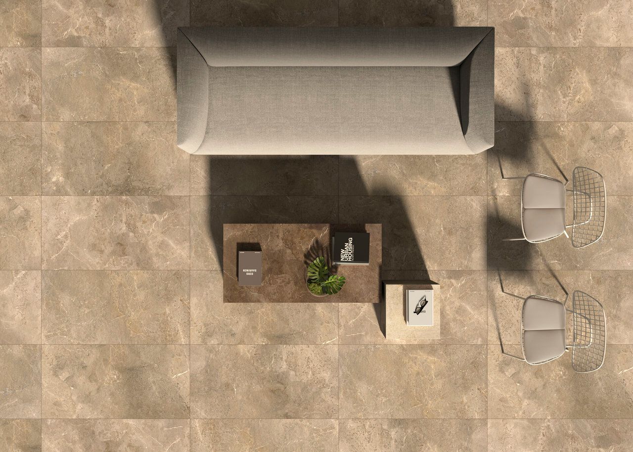 Overhead view of beige stone-look tiles with a sofa and chairs.