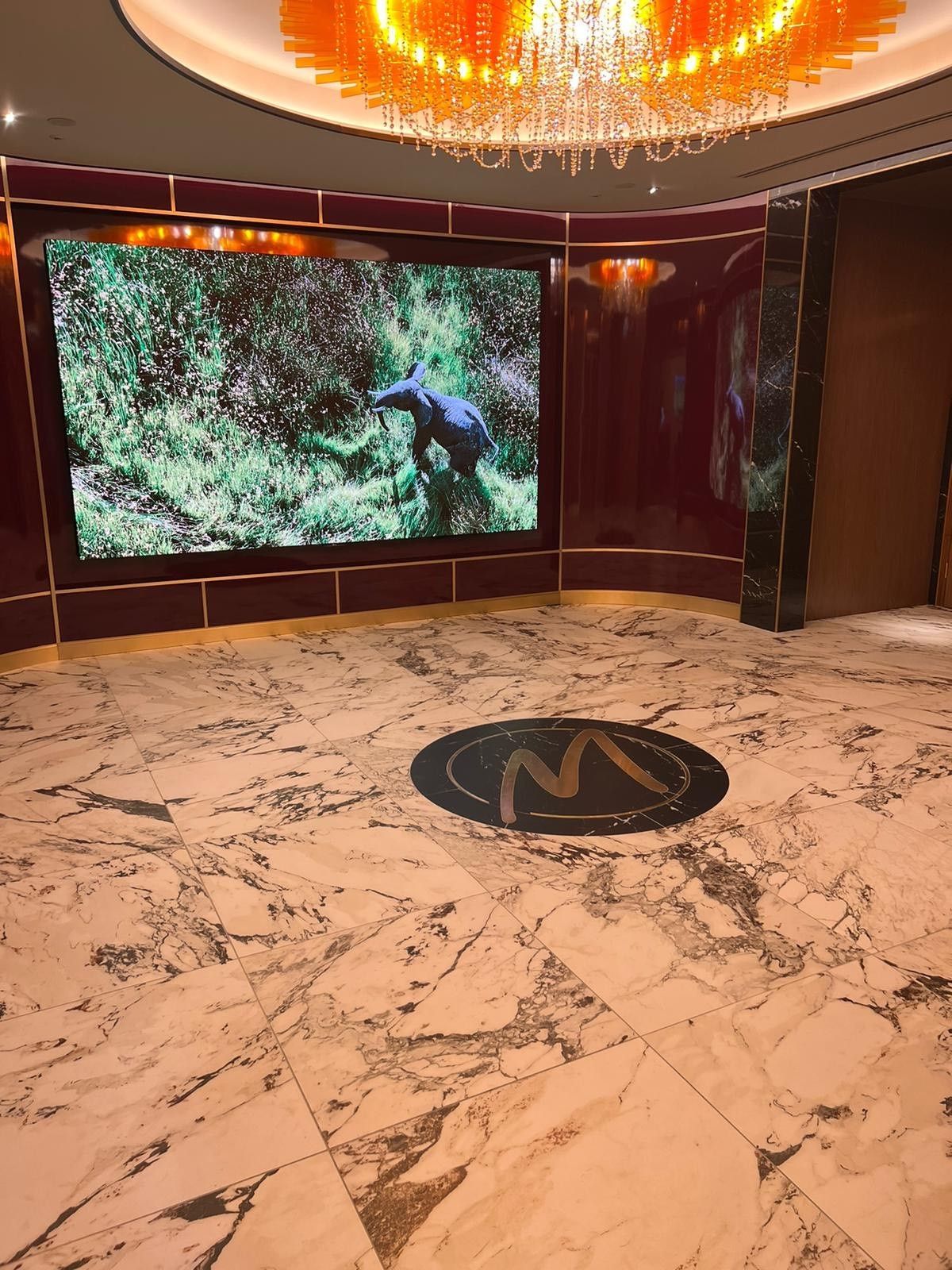 The logo of casino made from tiles in the marble floor
