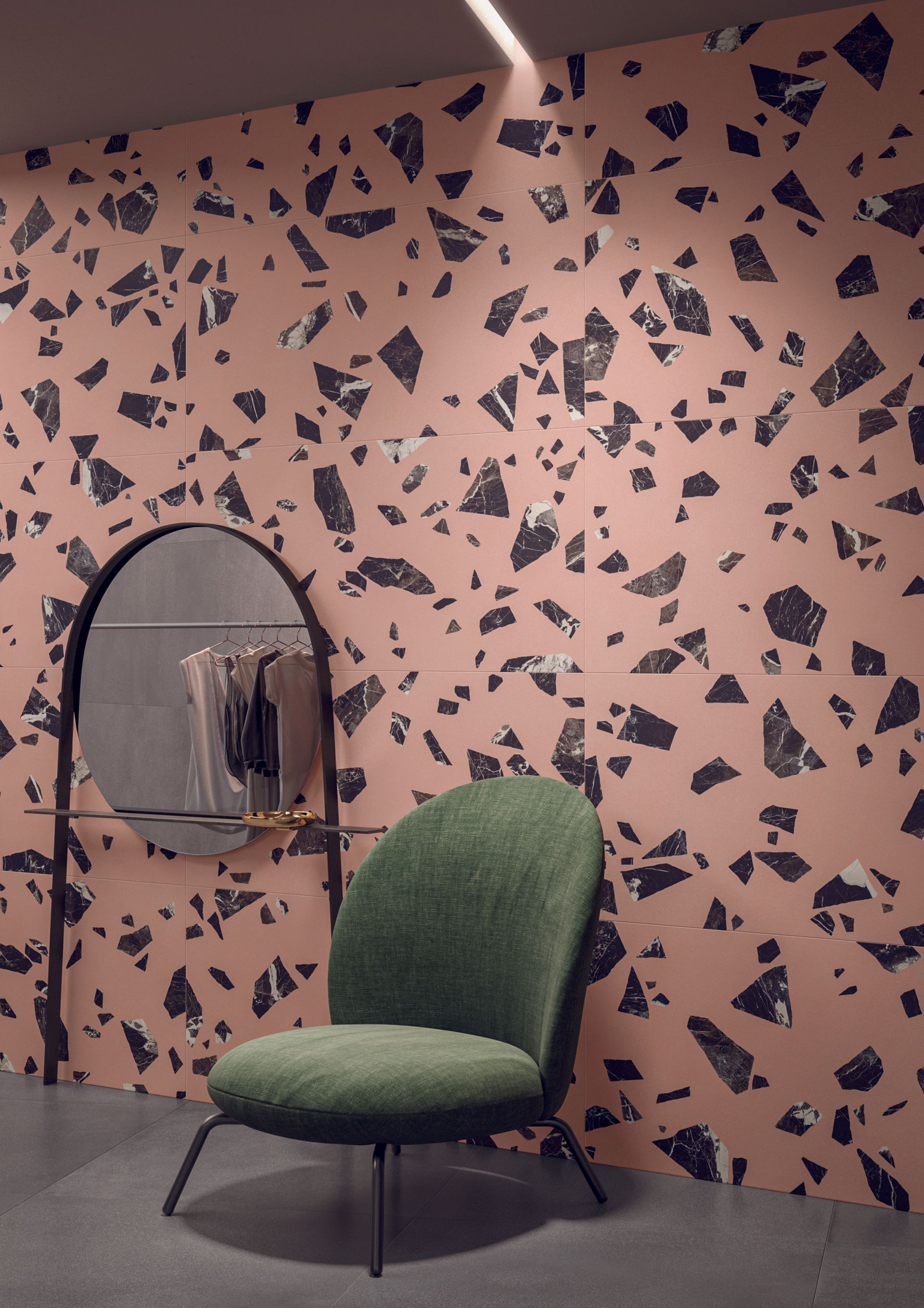 pink terrazzo tiles with black chunks and a couch seat in front of them