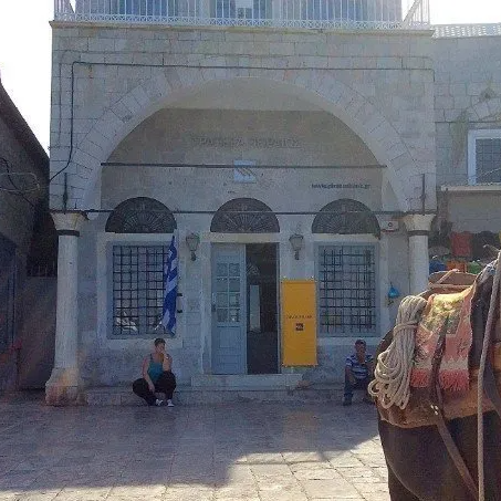 Piraeus Bank on Hydra on the harbour opposite the area where the mules gather. Piraeus Bank on Hydra Island Greece