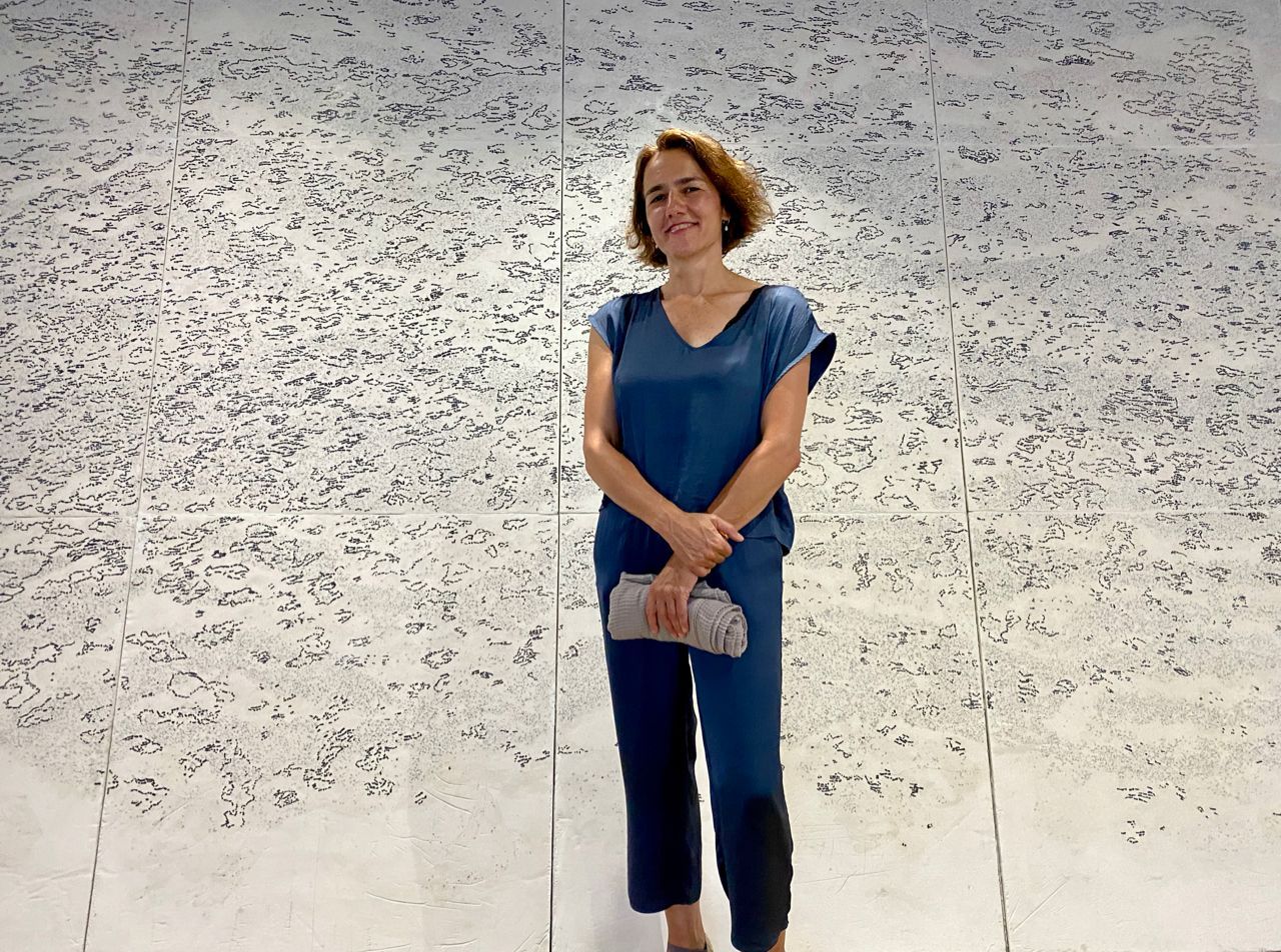 Artist Christina Nakou in front of her marble mosaic during the opening of the Hydra School Projects 2023 on Hydra Island Greece.