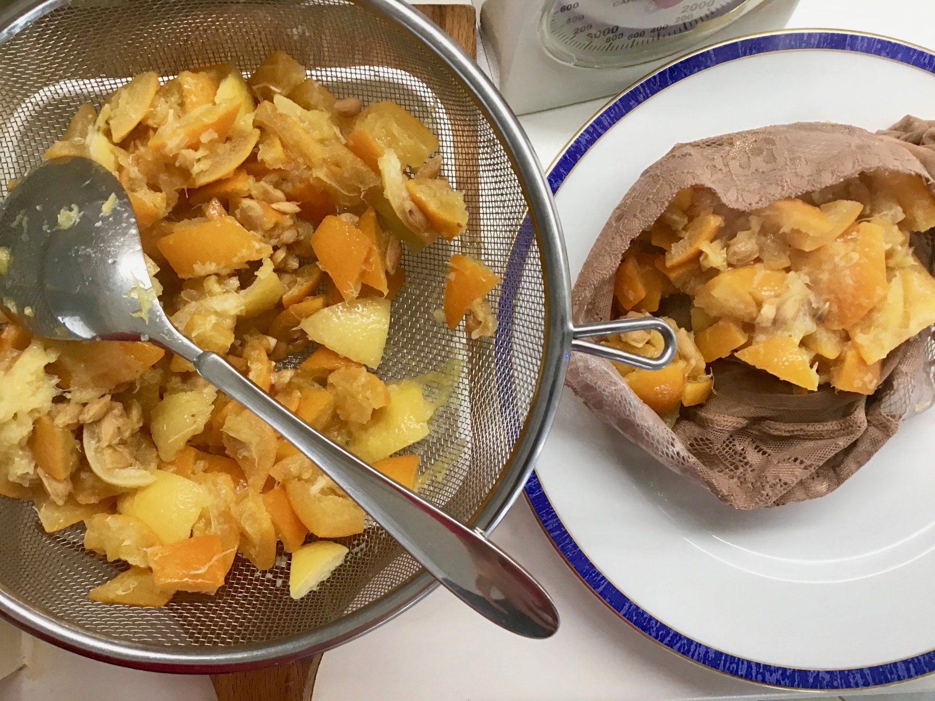 Using an old stocking to squeeze pectin out of fruit for marmalade making on Hydra Island Greece.
