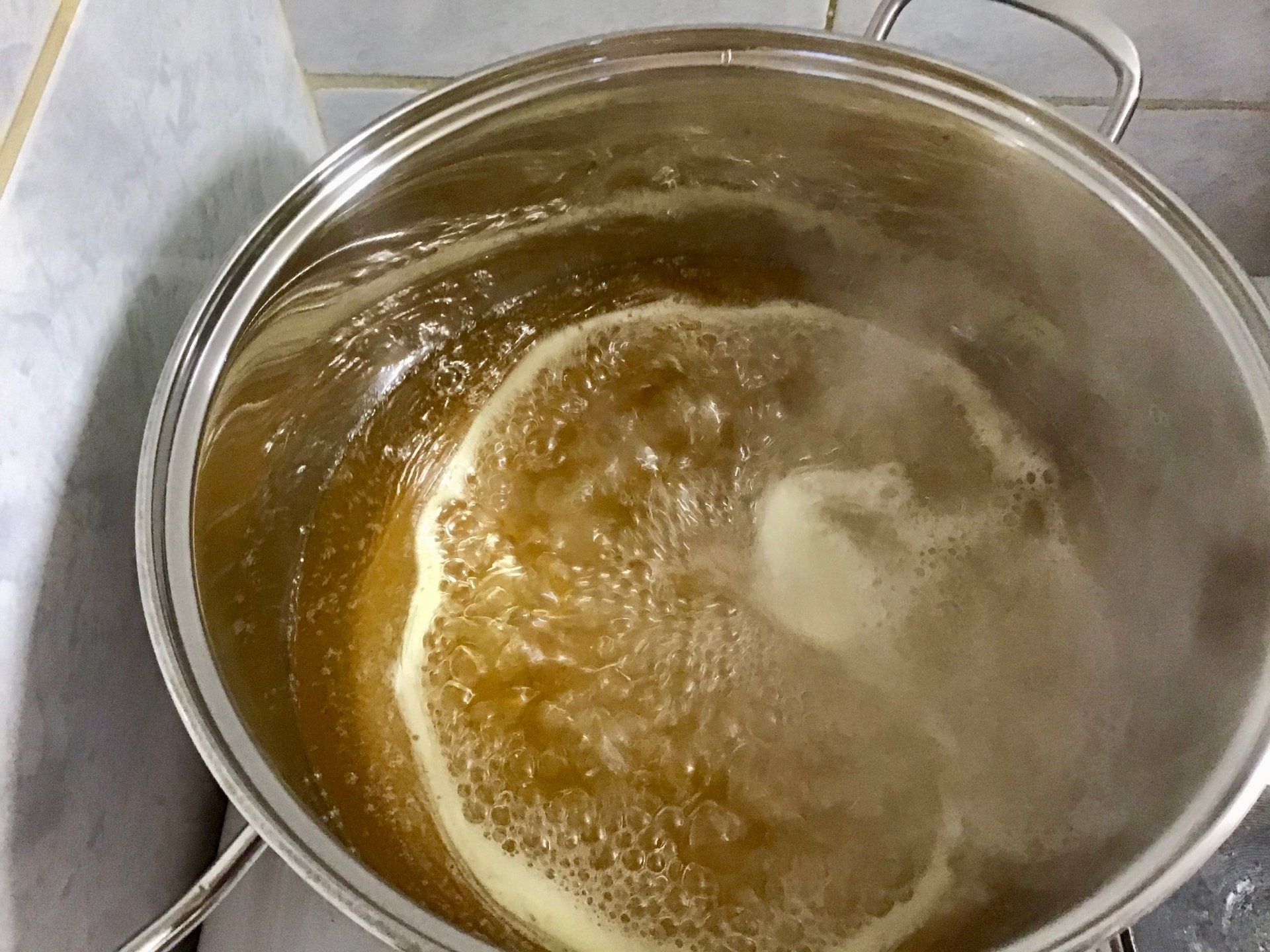 When the syrup reaches boiling point, start timing - making marmalade on Hydra Island Greece.