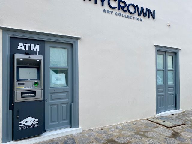 ATM machine in side wall of the My Crown gallery, off the east corner of Hydra harbour.