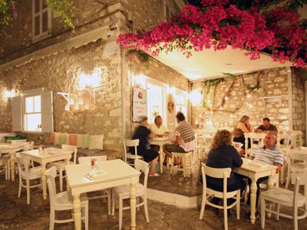Kai Kremmidi Restaurant at night on Hydra Island Greece.
