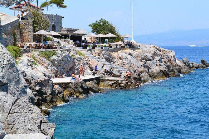 Bathing rocks and platforms below the Spilia Cafe on Hydra Island Greece.