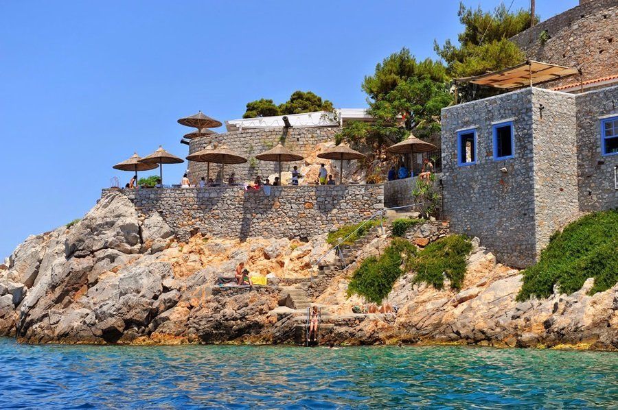 Bathing rocks and platforms below the Hyronetta Bar on Hydra Island Greece.