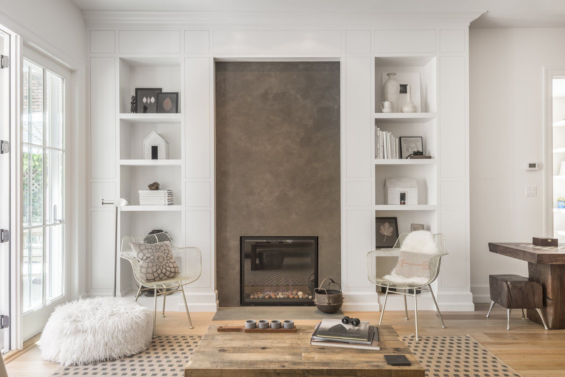 Built in cabinets surround plaster fireplace, contemporary cottage