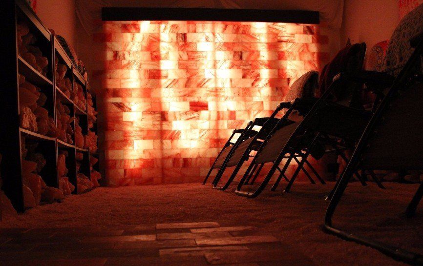 What is Halotherapy? Halotherapy, also known as dry Salt Therapy is a holistic approach that mimics the microclimate of a salt cave. Dry salt air is dispersed into an enclosed environment through a unique process generated by a halogenerator. This type of treatment is a safe and effective way of using salt’s natural antibacterial, anti-inflammatory and super absorbent properties to provide relief for respiratory and skin conditions. When you heat salt, it becomes super dry, and kinetically more active. This heated and dry pure sodium chloride is then crushed into micro-sized particles and dispersed into the air in an enclosed environment. When micro-particles of dry salt is inhaled into the respiratory system, it does its job by absorbing and removing allergens, toxins and foreign substances in your lungs and throughout your respiratory tract. Salt also reduces any inflammation and opens airway passages making easier to breathe.