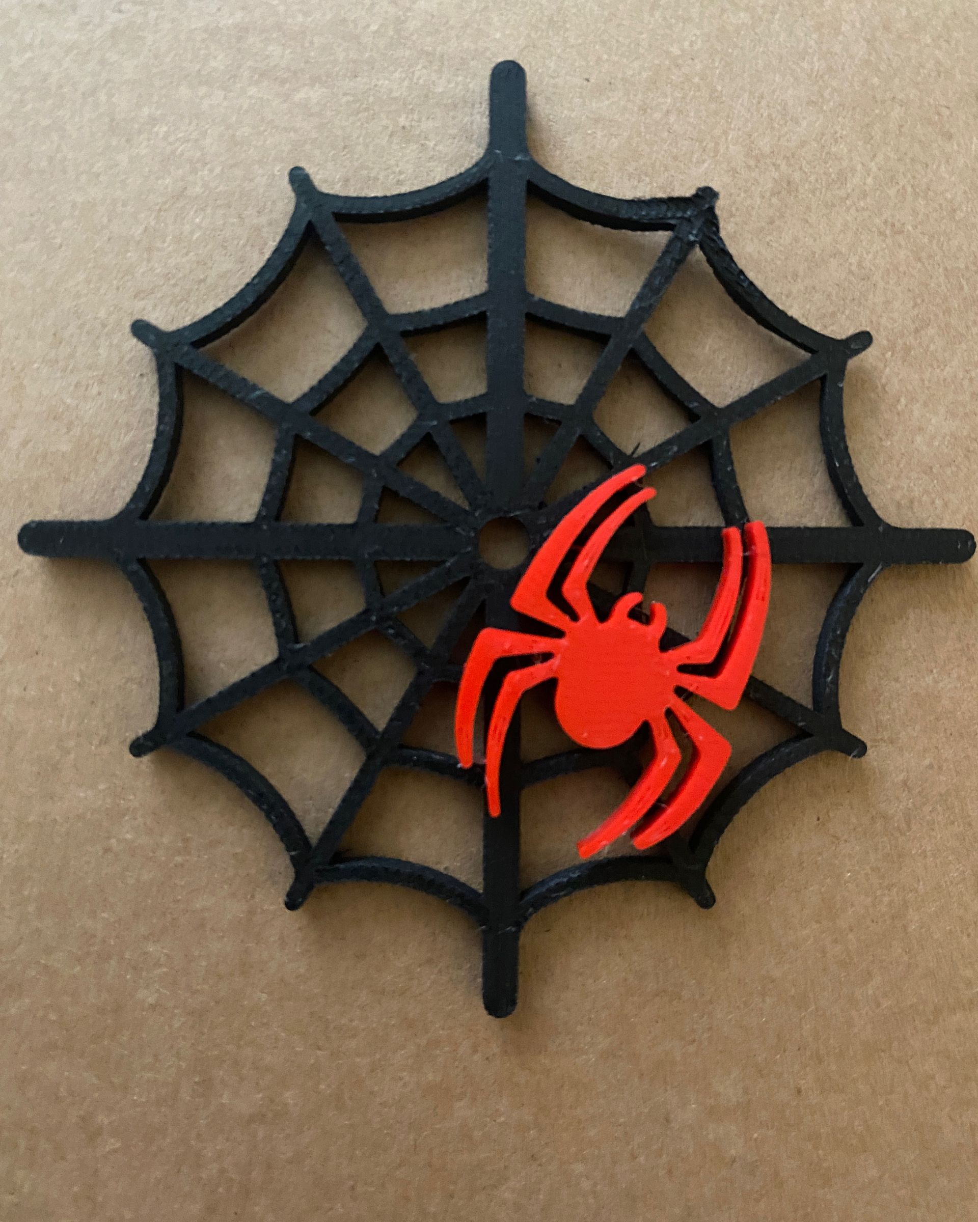 3D printed spider web and spider printed in black  and red PLA