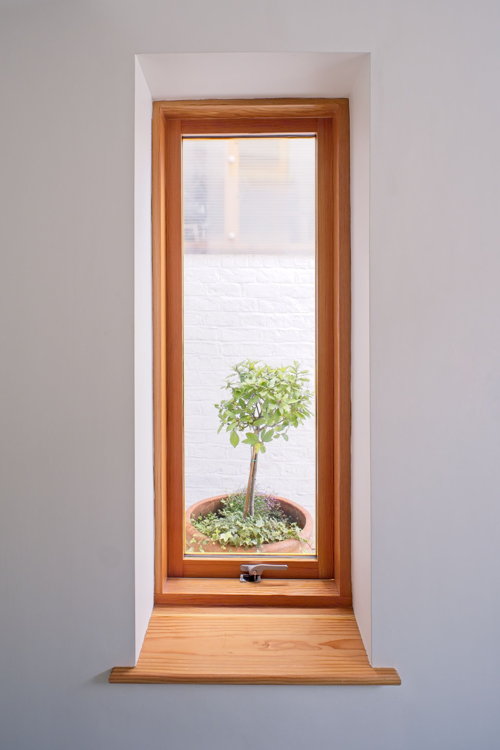 Small window seat and views added to terrace house in Liverpool by Human Architecture Studio