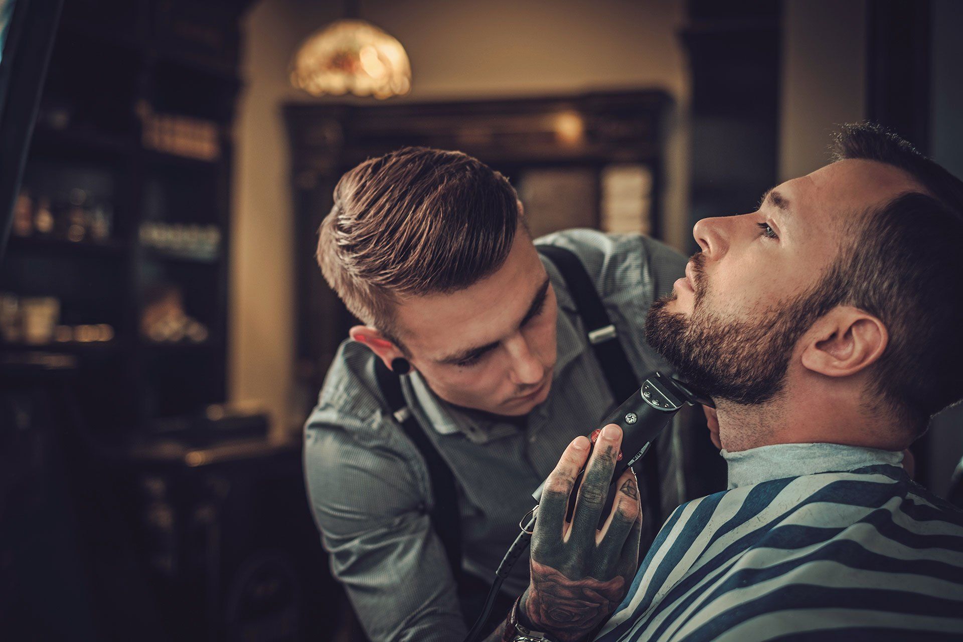 a barber cutting a mans beard
