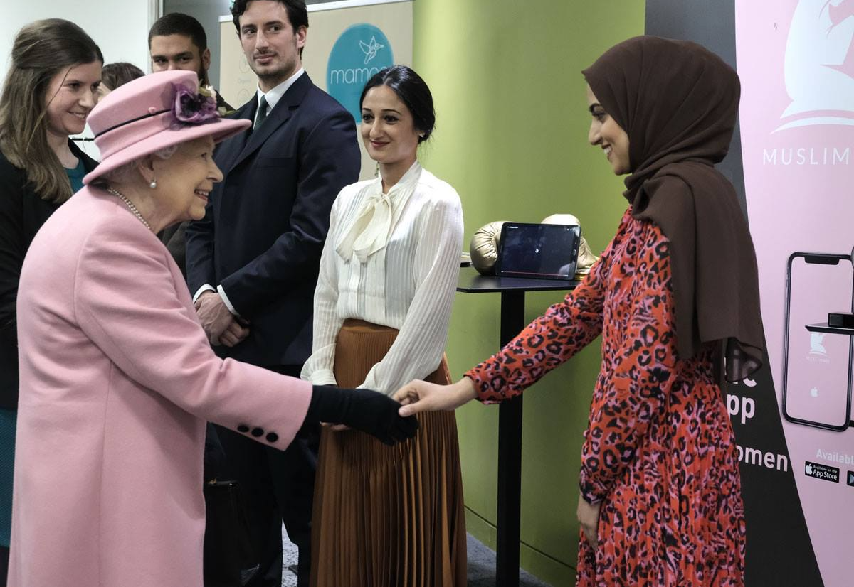 Her Majesty The Queen shaking hands with Aysha, Founder of Muslimah at the King's Entrepreneurship Institute.