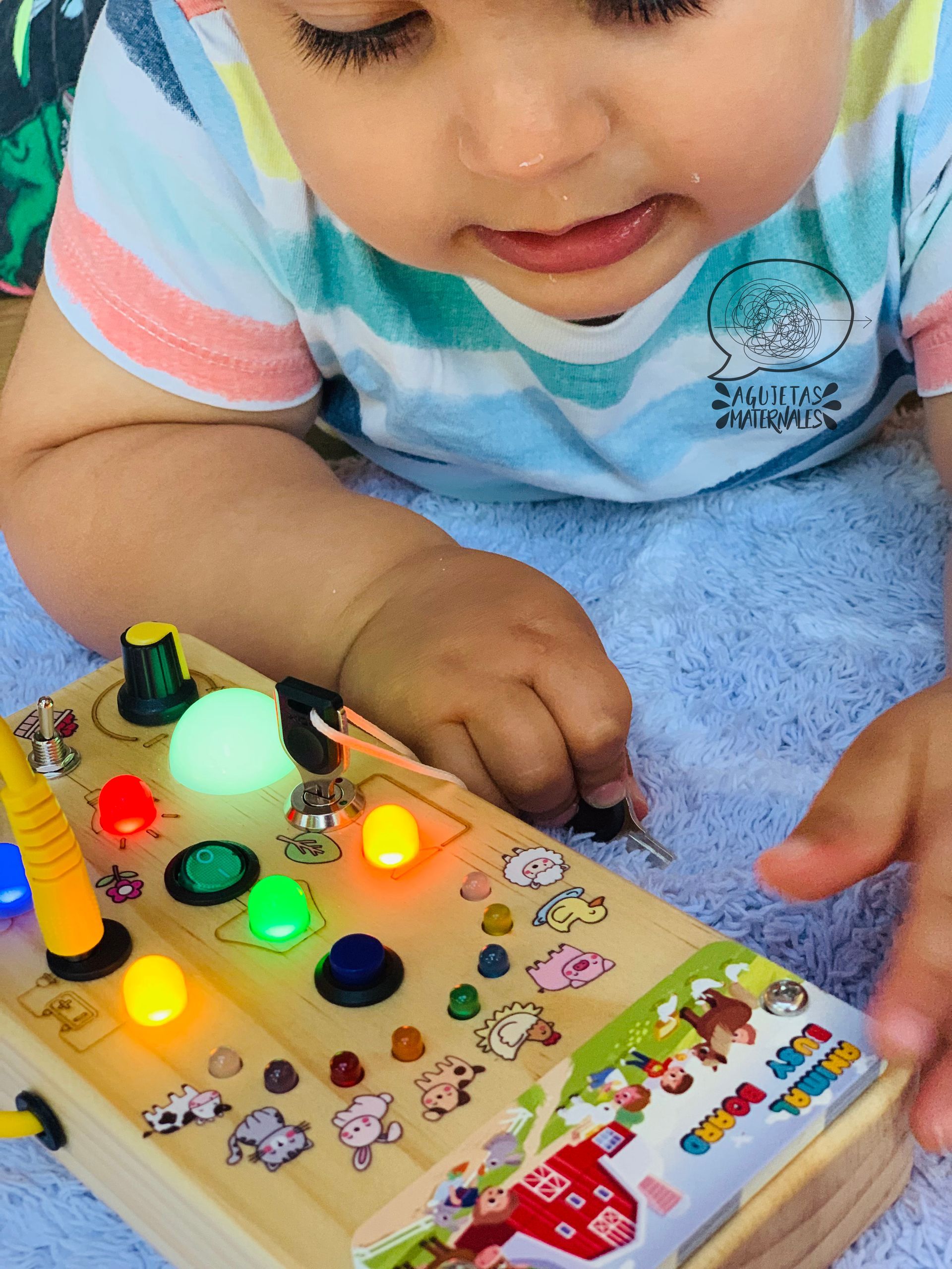 bebé jugando con un busy board
