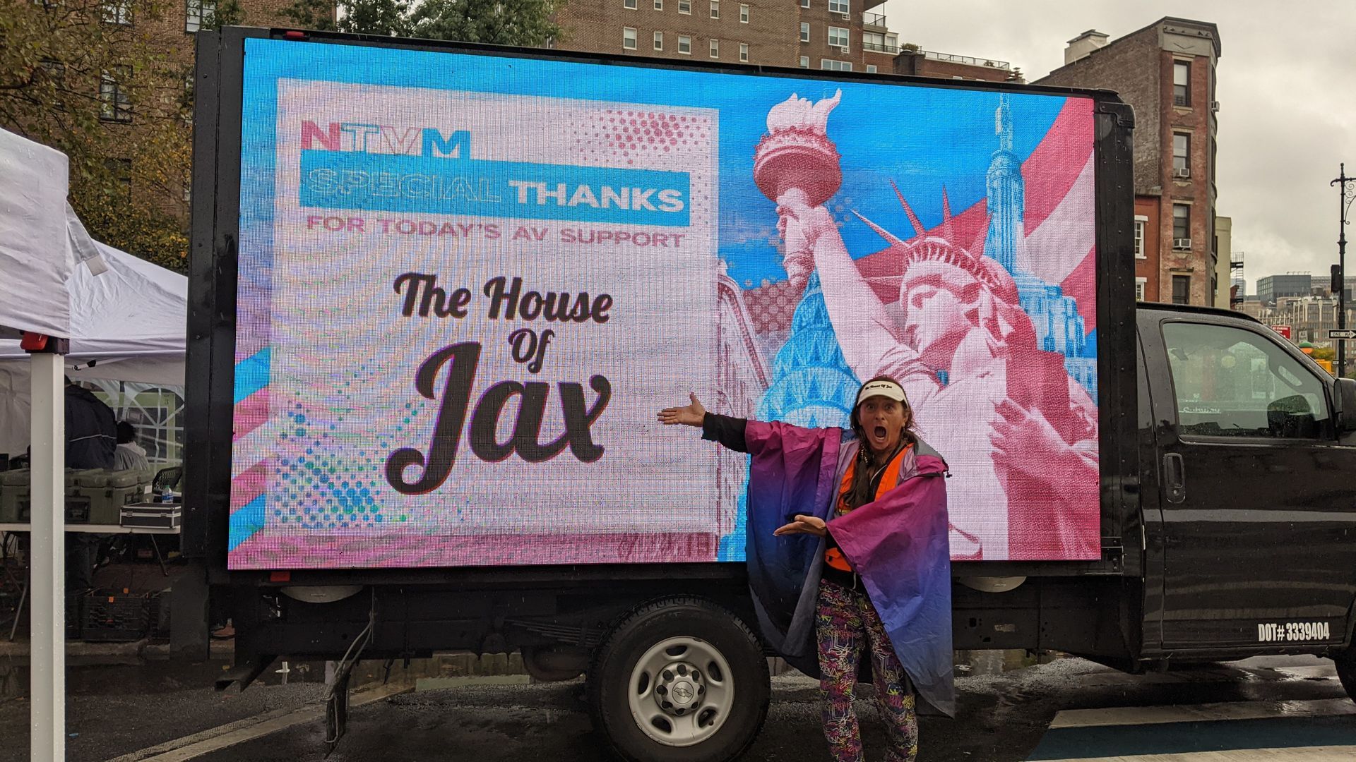 Nikki Jax pointing at HOJ Logo on truck