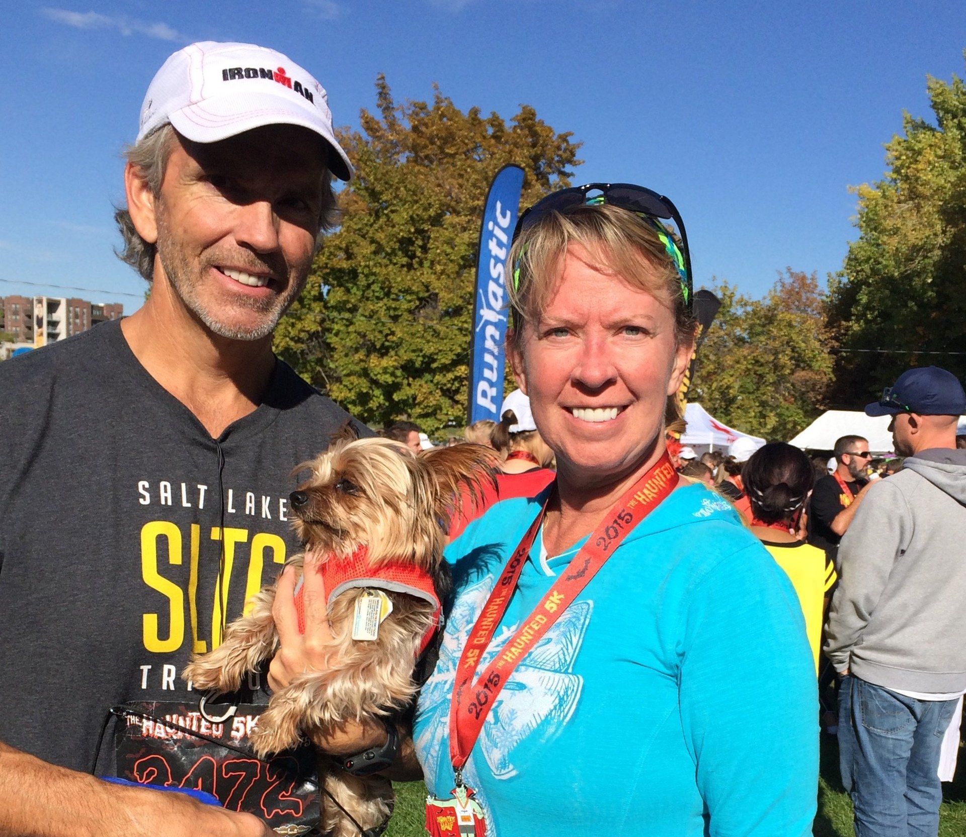 The Wrights holding their puppy dog after a race