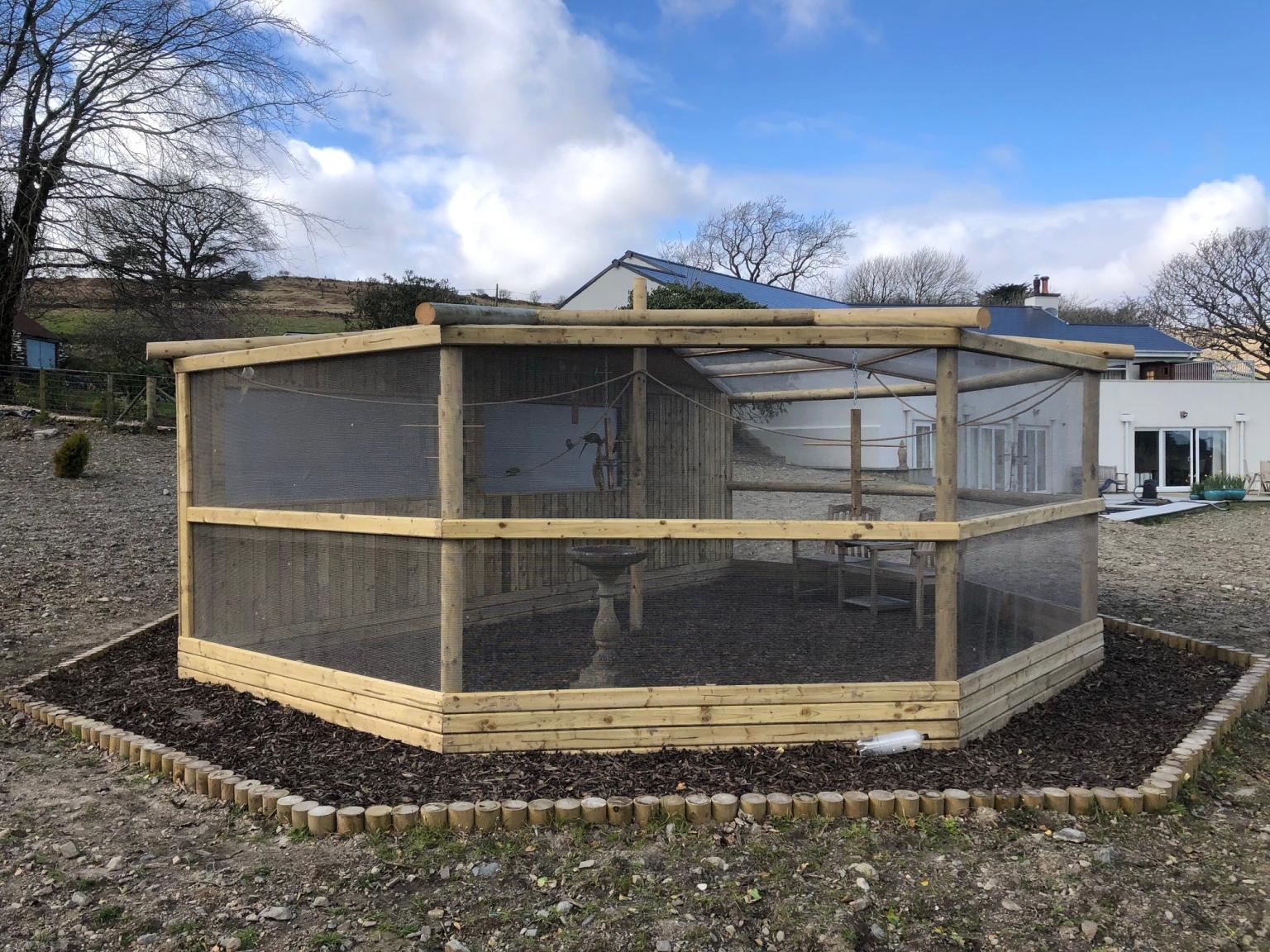 Hexagonal shaped wooden aviary with ClearMesh