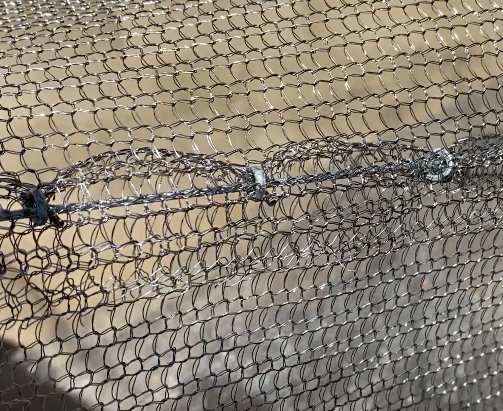Hog rings connecting two pieces of Clearmesh