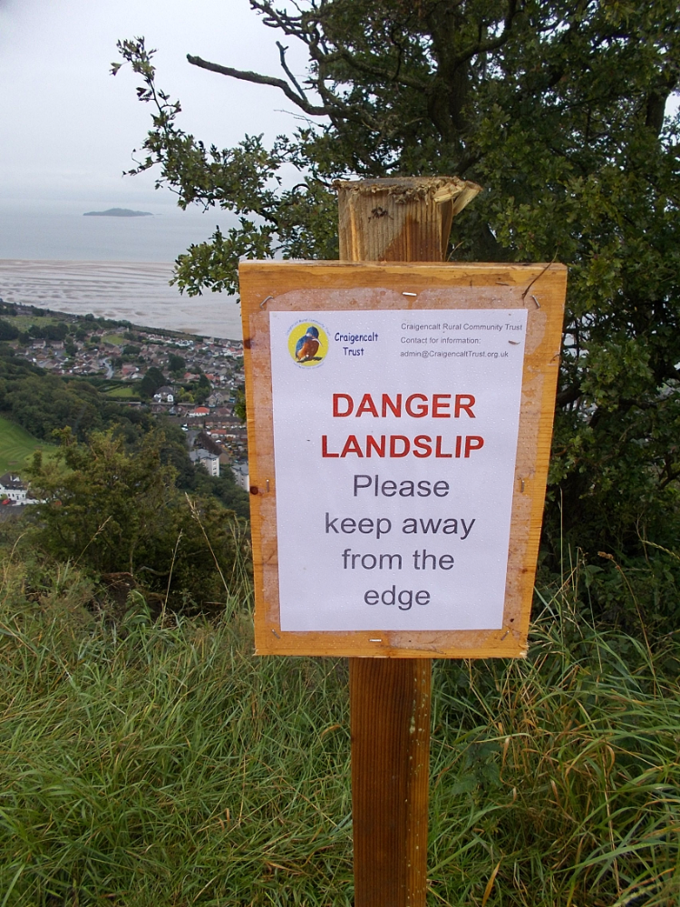 Sign on The Binn summit warning of landslip Diverting walkers away from the landslip on the summit of The Binn
