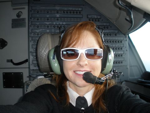 Captain Gina at the controls of the Canadair Regional Jet in flight.