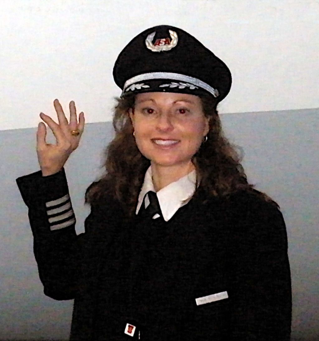 Gina M. Longo in uniform standing next to a jet.