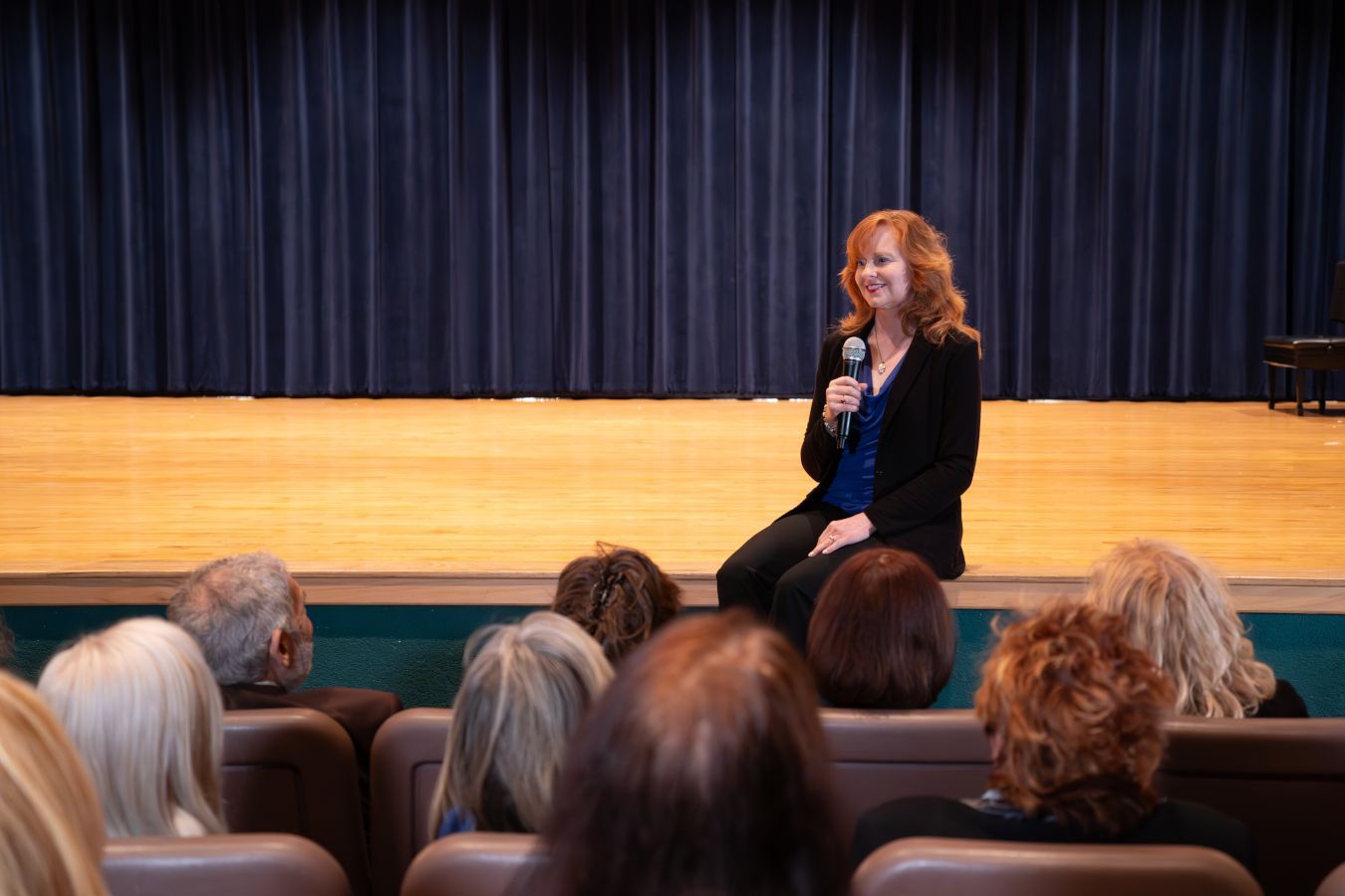 Gina M. Longo on stage at an event.