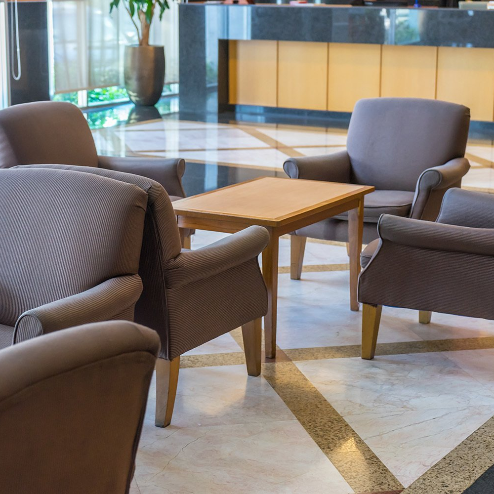 hotel reception area with upholstery chairs and tables
