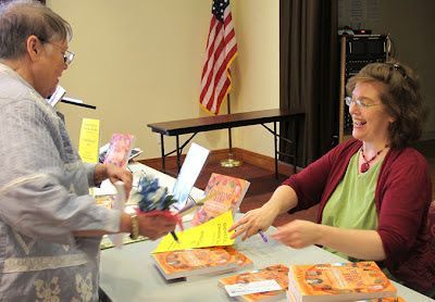 Marney Makridakis autographs her book for a DAFA member with a time-related name – Early Irwin.