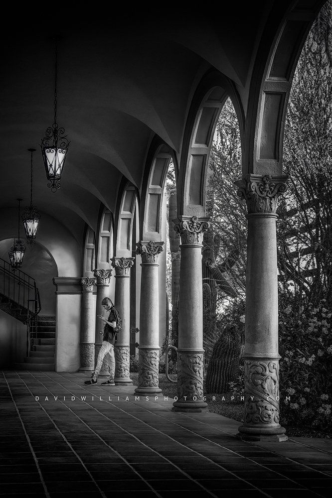 Black and white portrait of a girl leaning against church columns B+W of a girl leaning against columns at an old church