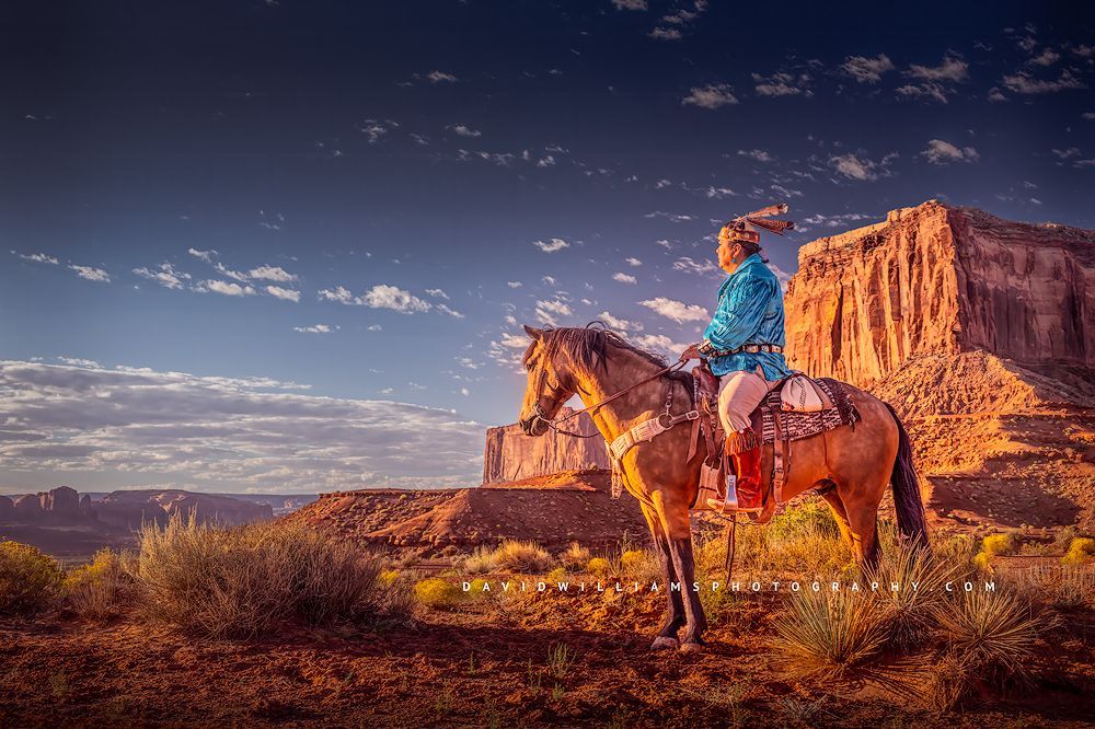 A Navajo Indian sitting on his horse as the sun rises, Monument Valley, AZ