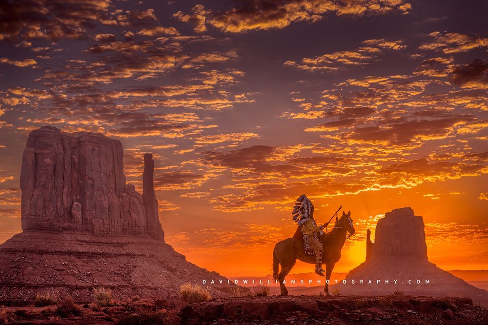 A Navajo Indian in tribal clothing on horseback at sunrise, Monument Valley