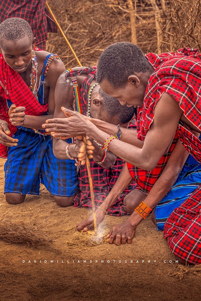Maasai warriors rubbing sticks creating fire, Amboseli, Kenya, Africa