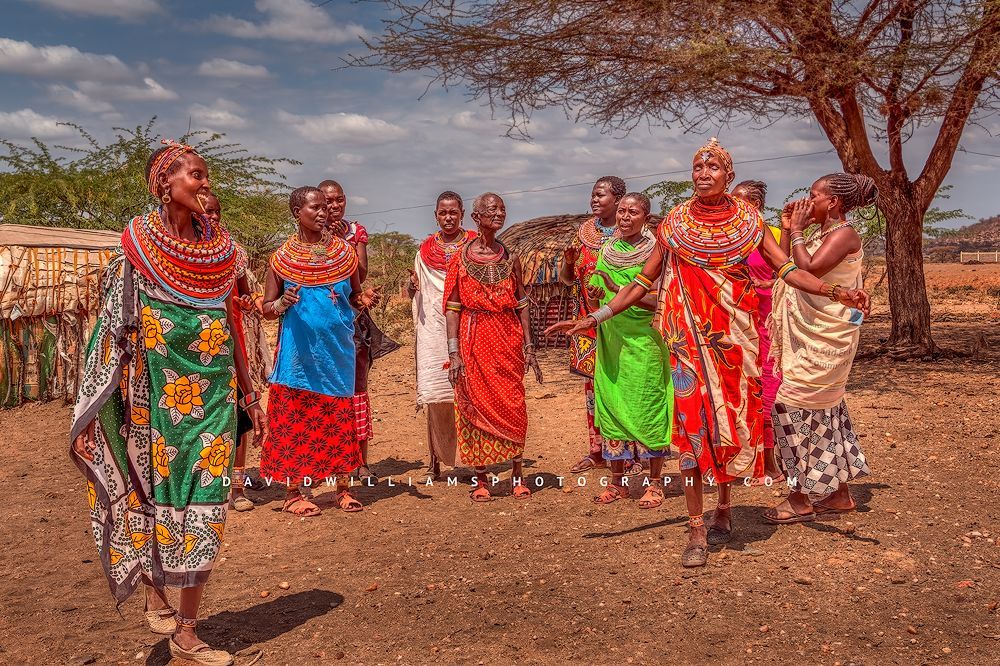 A group of Maasai women colorfully dancing in tribal clothing, Kenya